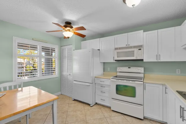 a kitchen with cabinets appliances and a sink