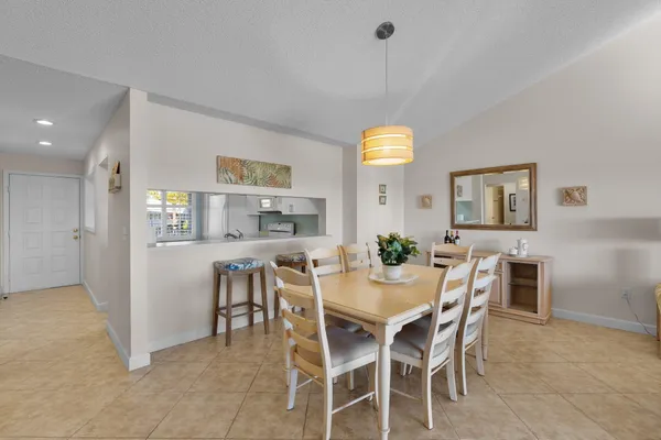 a view of a dining room with furniture and a chandelier