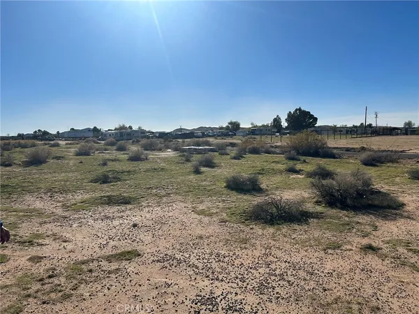 a view of a dirt road and mountain view
