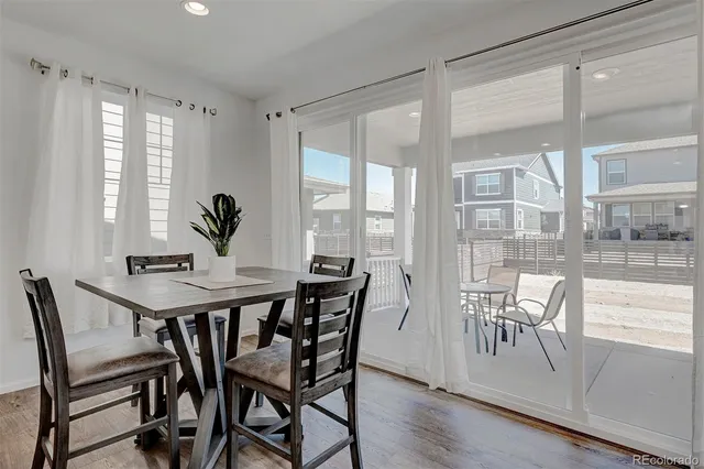 a view of a dining room with furniture window and wooden floor