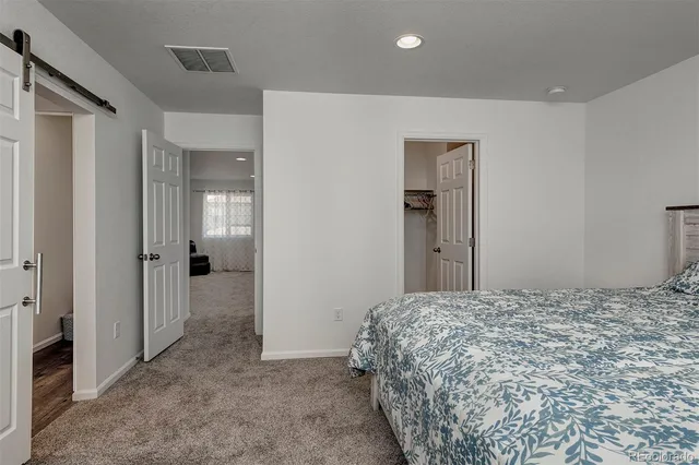 a bedroom with a bed and a bathroom