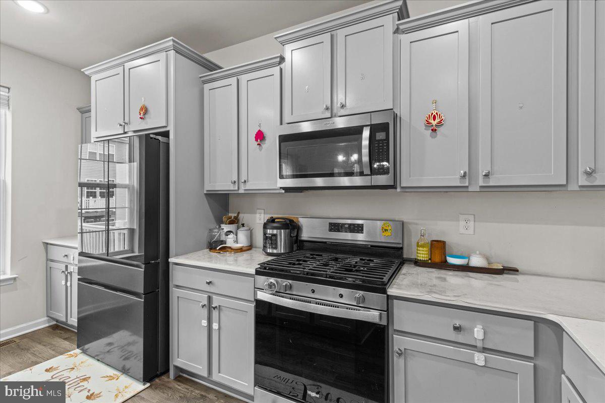 9 Sister's Farmstead Road Mount Laurel, NJ 08054 - Photo 20 of 43 a kitchen with stainless steel appliances granite countertop a stove a microwave and a refrigerator