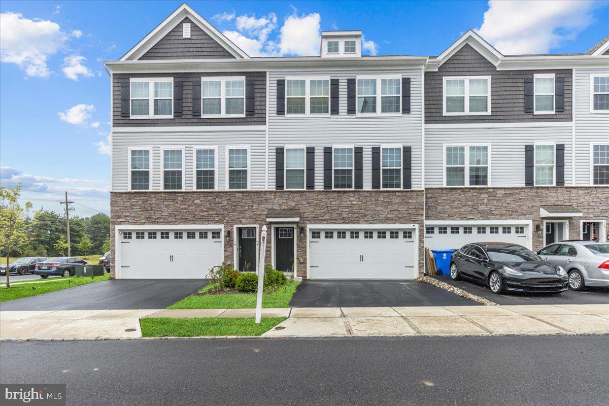 9 Sister's Farmstead Road Mount Laurel, NJ 08054 - Photo 3 of 43 a front view of a building with a yard and a car parked in front of it