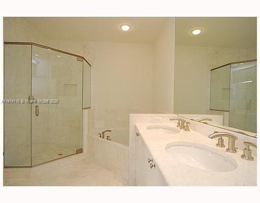 901 Brickell Key Boulevard, Unit 705 Miami, FL 33131 - Photo 11 of 41 a bathroom with a sink a toilet a shower and a mirror