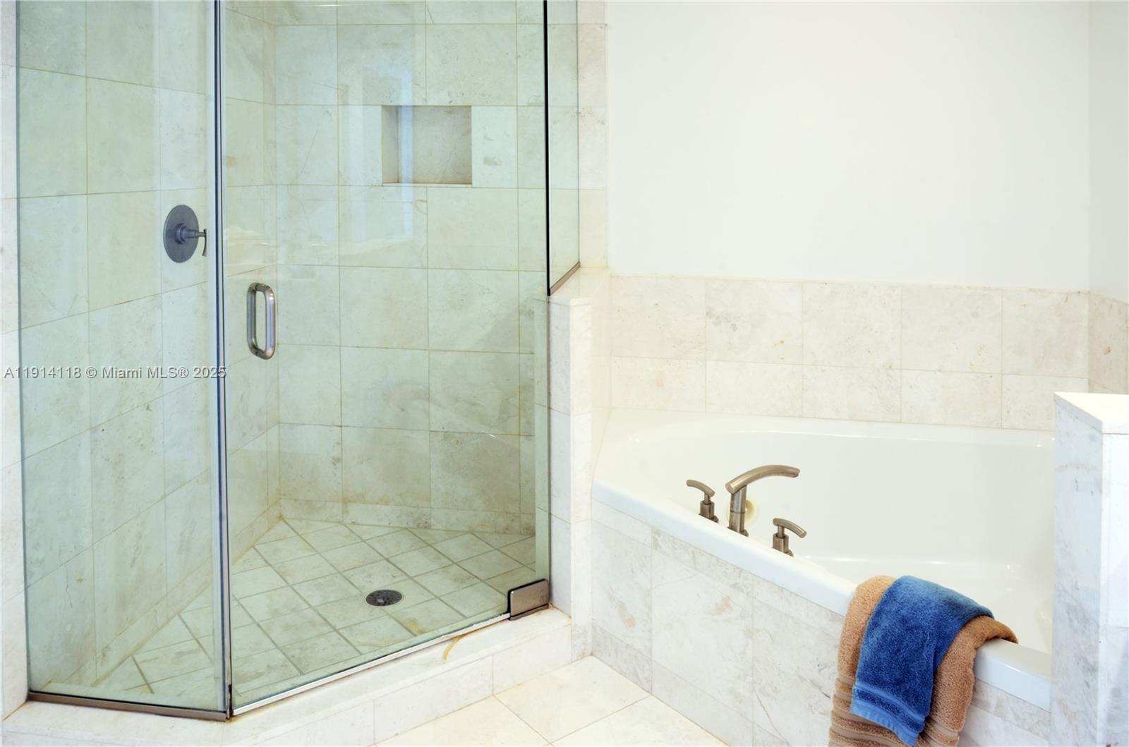 901 Brickell Key Boulevard, Unit 705 Miami, FL 33131 - Photo 13 of 41 a bathroom with a bathtub and shower