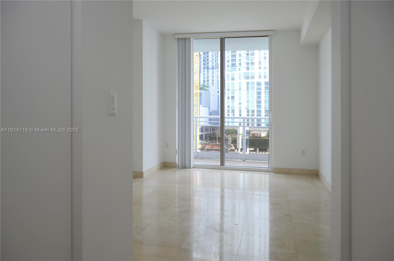 901 Brickell Key Boulevard, Unit 705 Miami, FL 33131 - Photo 20 of 41 a view of an empty room with wooden floor and a window