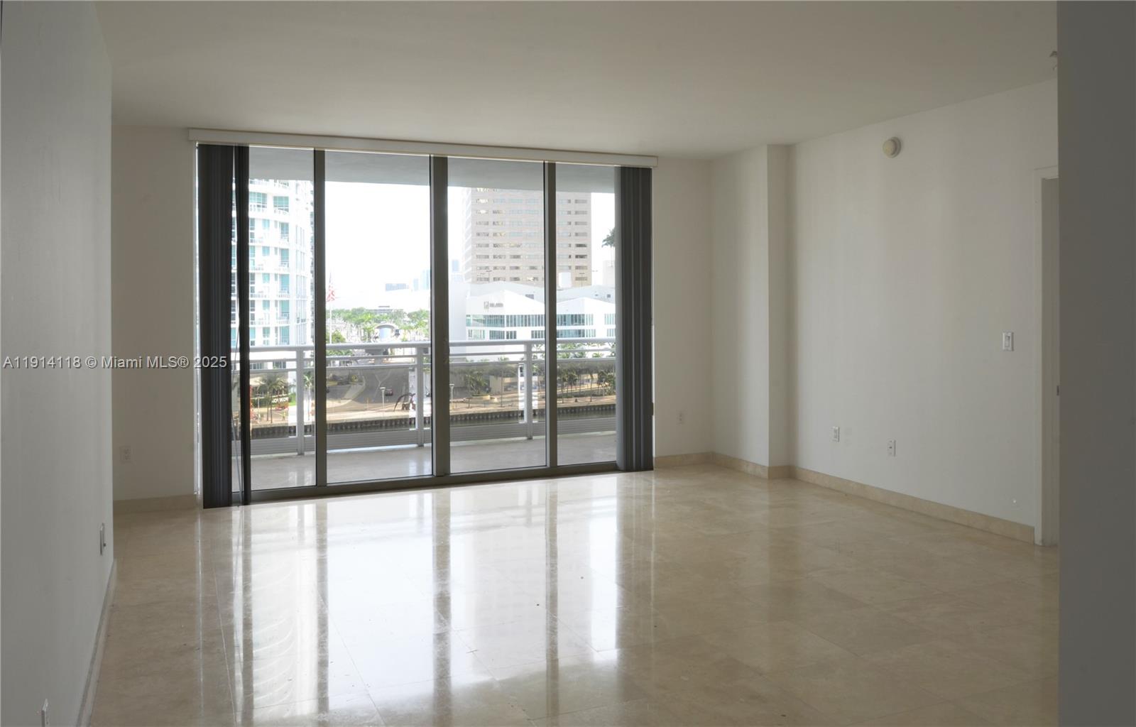 901 Brickell Key Boulevard, Unit 705 Miami, FL 33131 - Photo 2 of 41 a view of an empty room with glass windows