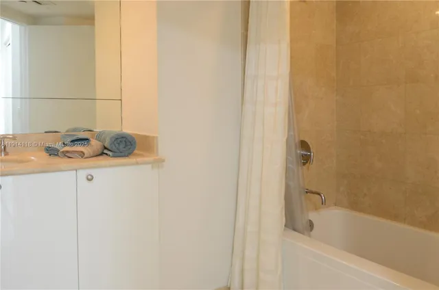 a bathroom with a tub and sink