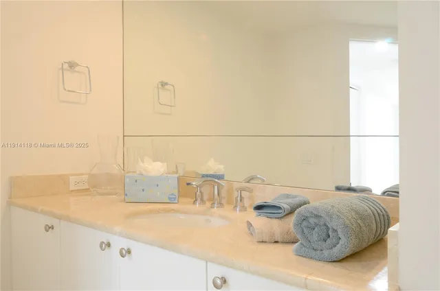 a bathroom with a sink and mirror