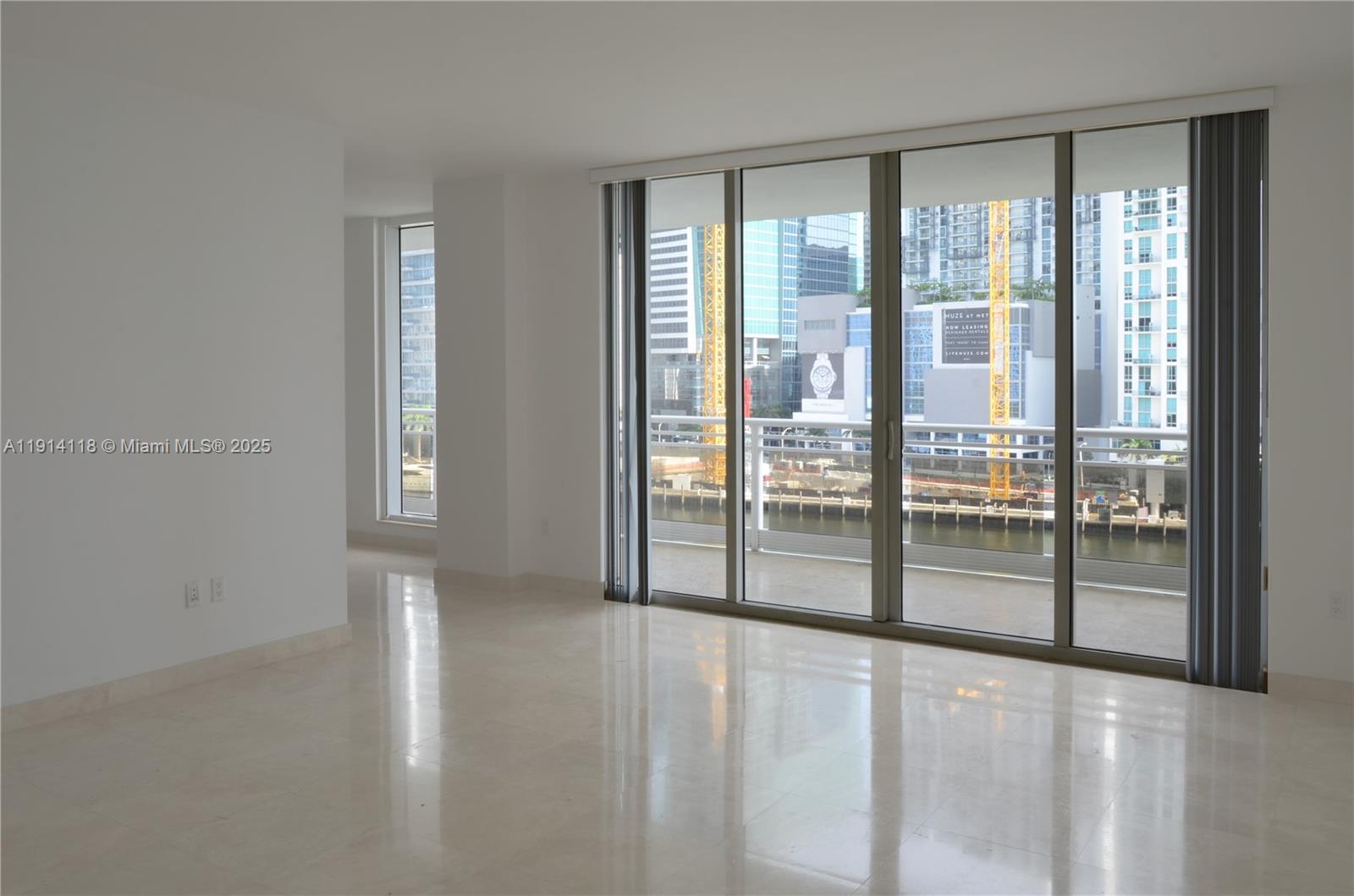 901 Brickell Key Boulevard, Unit 705 Miami, FL 33131 - Photo 3 of 41 a view of an empty room with windows
