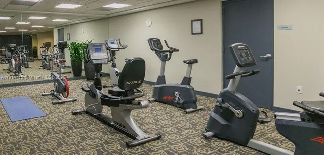 a room with gym equipment and mirror
