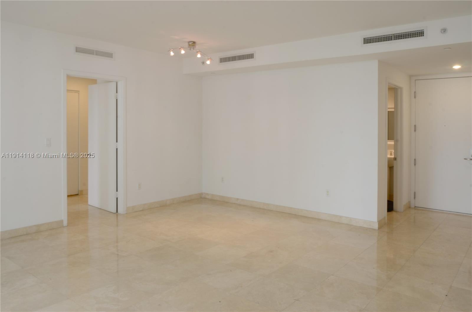 901 Brickell Key Boulevard, Unit 705 Miami, FL 33131 - Photo 5 of 41 an empty room with a door