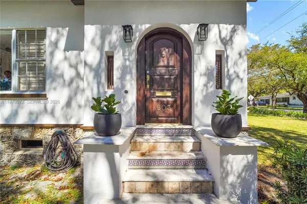 a view of hall with wooden floor and a potted plant
