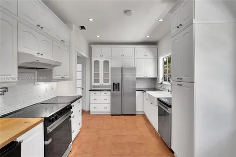 a kitchen with granite countertop a sink stove and cabinets