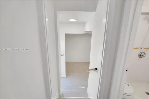 a view of a bathroom from a hallway