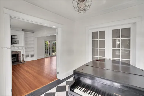 a living room with fireplace furniture and a floor to ceiling window