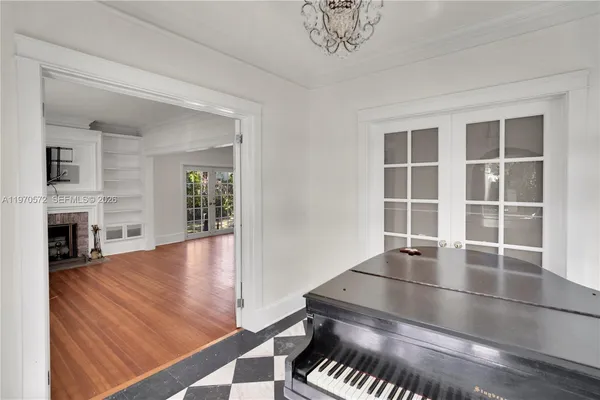 a view of a livingroom with wooden floor a fireplace and windows