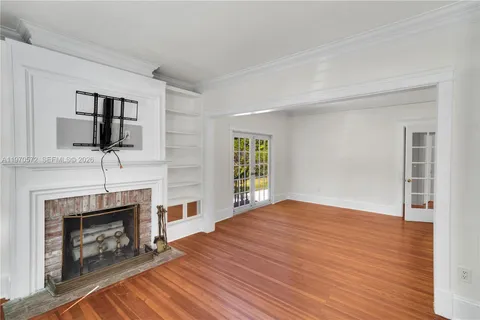 a bedroom with a fireplace and a television