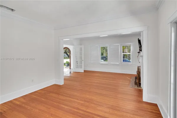 a view of empty room with wooden floor and fireplace