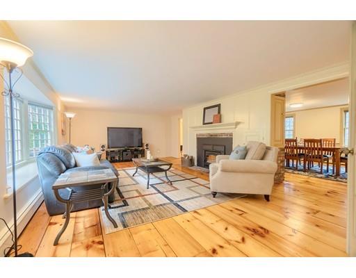 99 Herrick Road Boxford, MA 01921 - Photo 20 of 30 a living room with furniture a fireplace and a flat screen tv