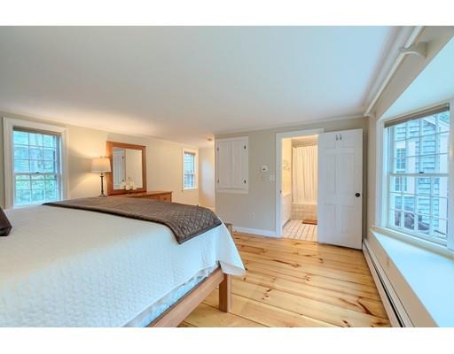 99 Herrick Road Boxford, MA 01921 - Photo 23 of 30 a bedroom with a large bed and wooden floor