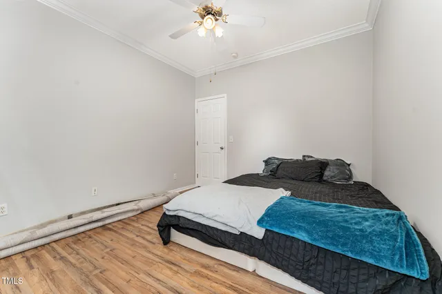 a bedroom with a bed and a chandelier