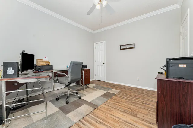 a view of a workspace with furniture and a window