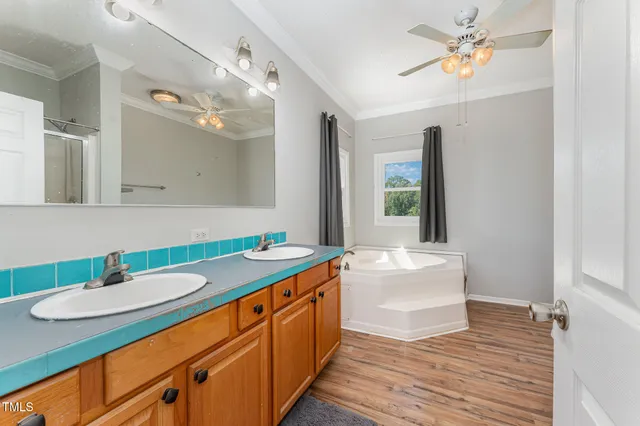 a bathroom with a sink double vanity granite and a mirror