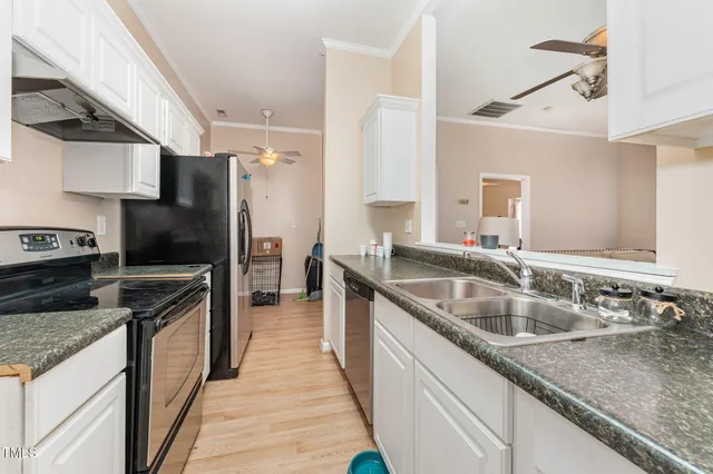 a kitchen with granite countertop a sink and stainless steel appliances