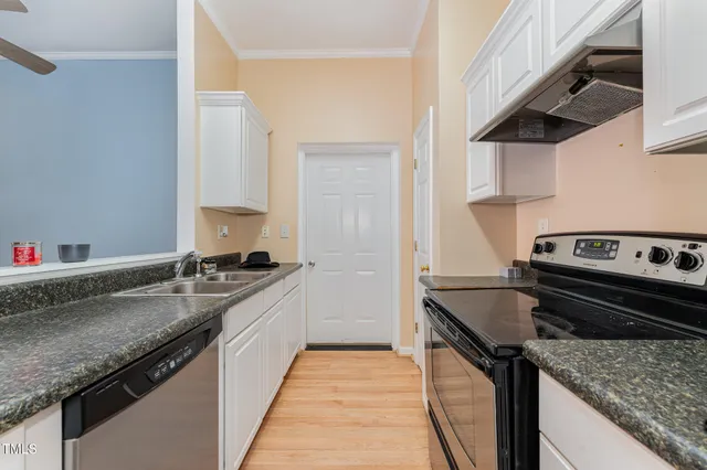 a kitchen with a sink stove and cabinets