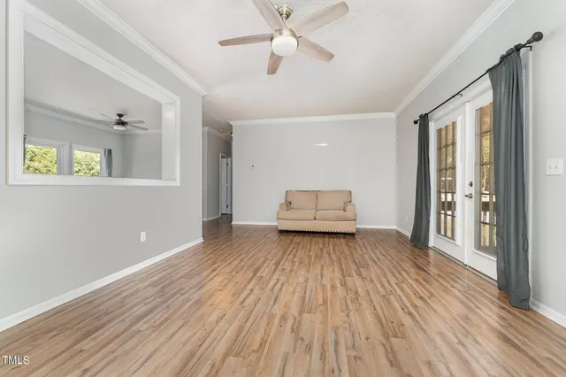wooden floor in an empty room with a window