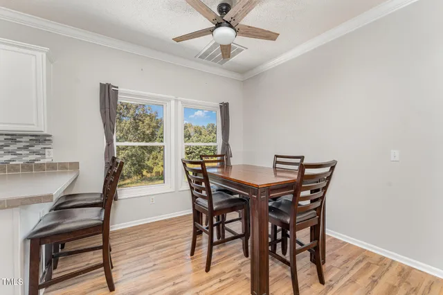 a view of a dining room with furniture and wooden floor
