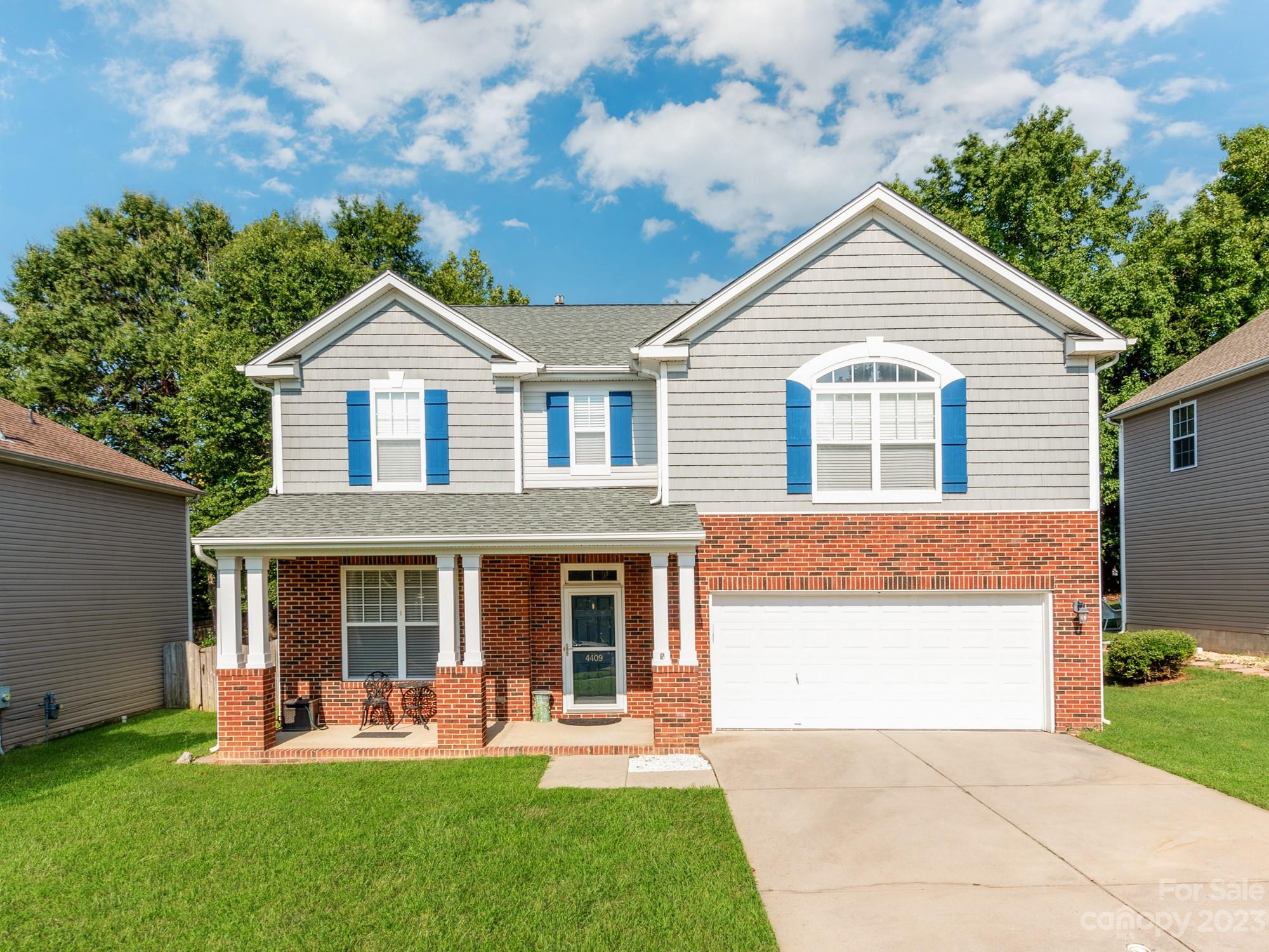 a front view of a house with a yard and porch