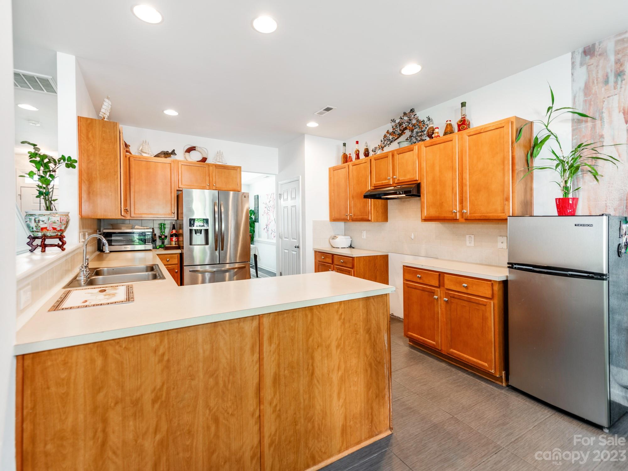 4409 Lawrence Daniel Drive Matthews, NC 28104 - Photo 12 of 38 a kitchen with stainless steel appliances a sink and a refrigerator