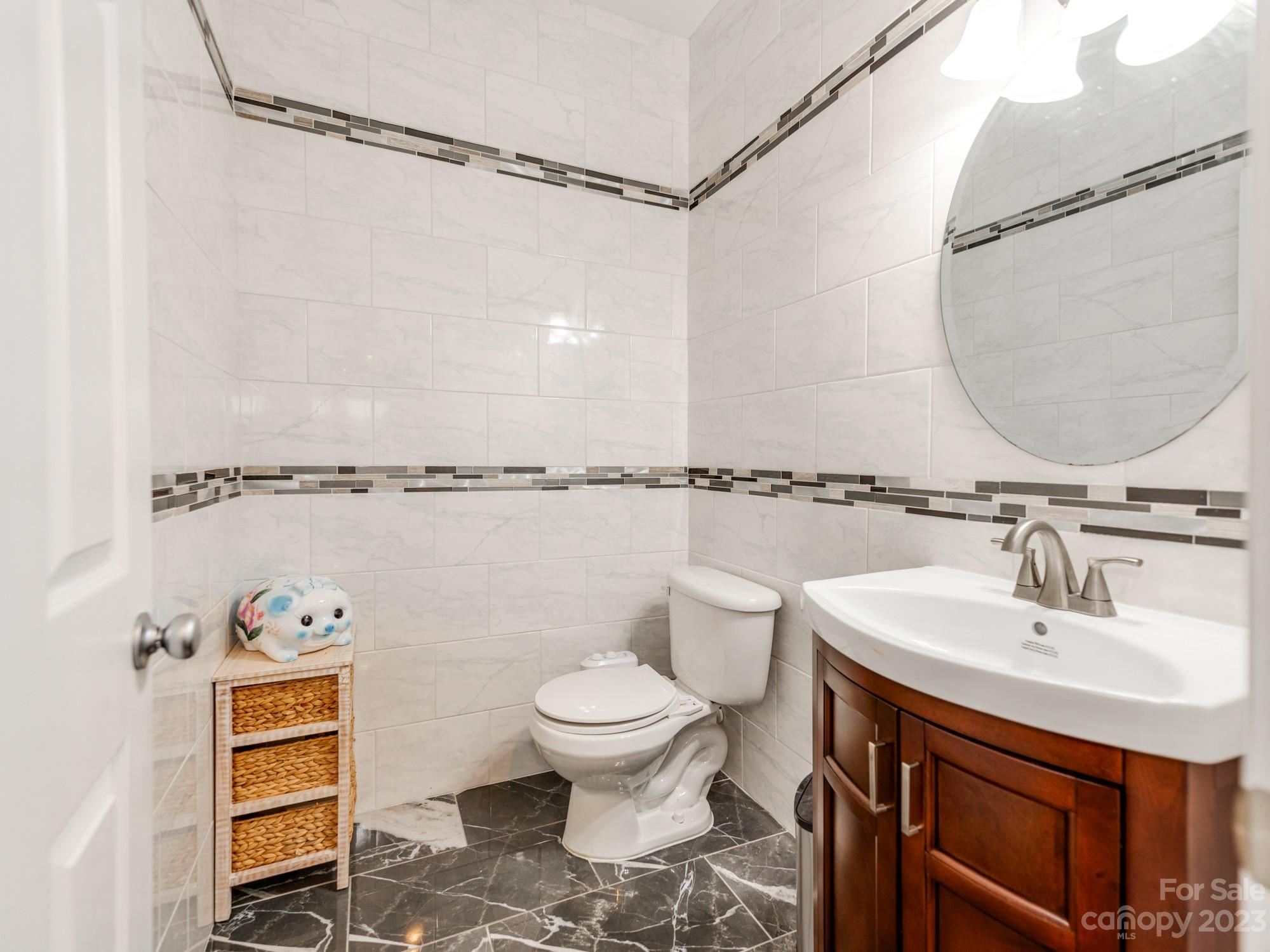 4409 Lawrence Daniel Drive Matthews, NC 28104 - Photo 19 of 38 a bathroom with a sink a toilet and a mirror