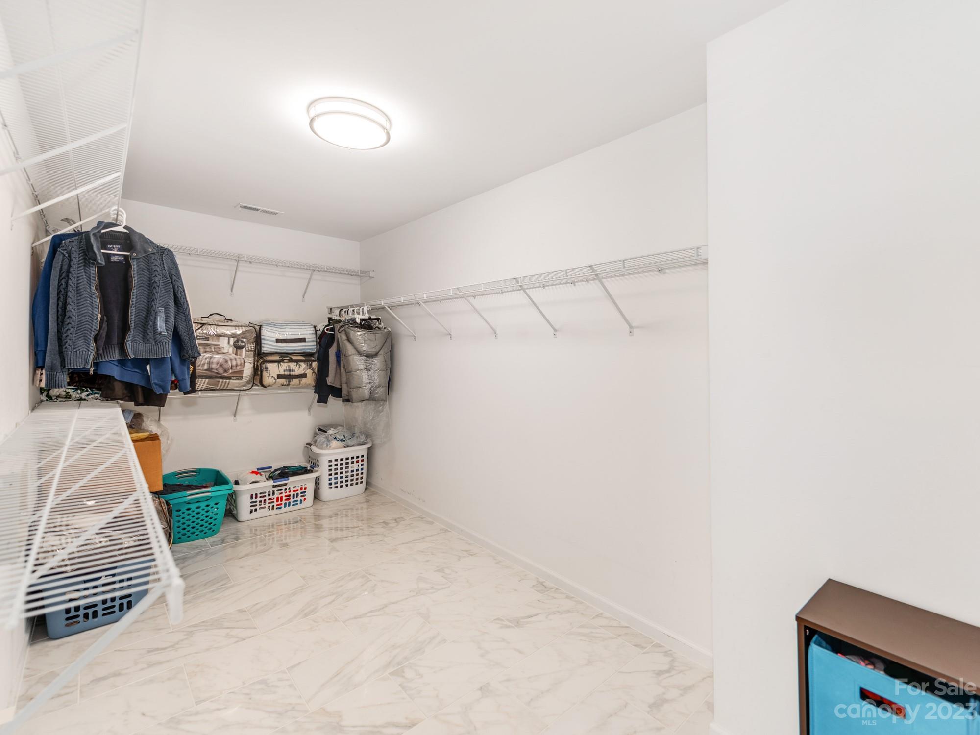 4409 Lawrence Daniel Drive Matthews, NC 28104 - Photo 25 of 38 a view of walk in closet with clothes and shoes