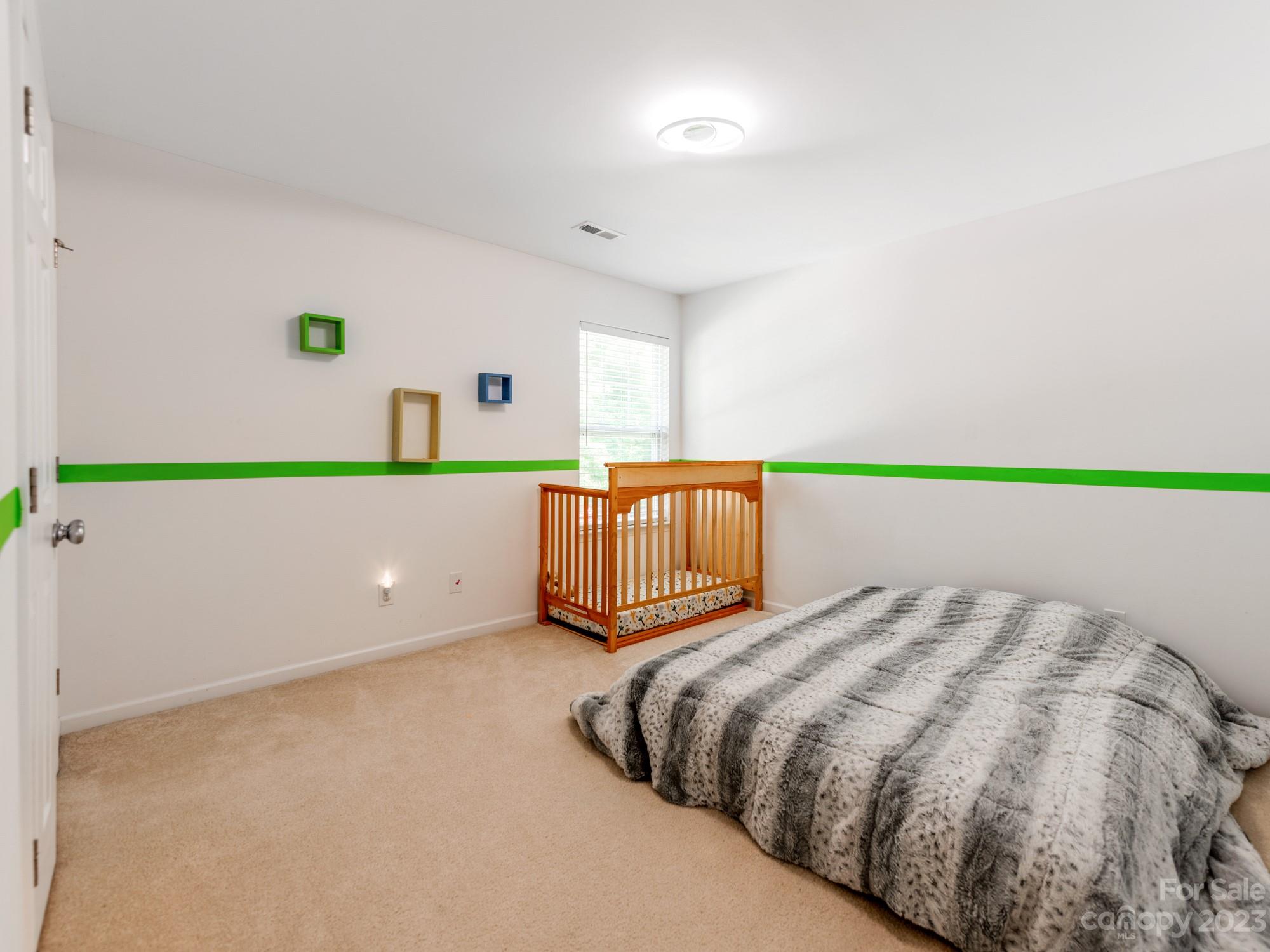 4409 Lawrence Daniel Drive Matthews, NC 28104 - Photo 30 of 38 a bedroom with a bed and a painting on the wall