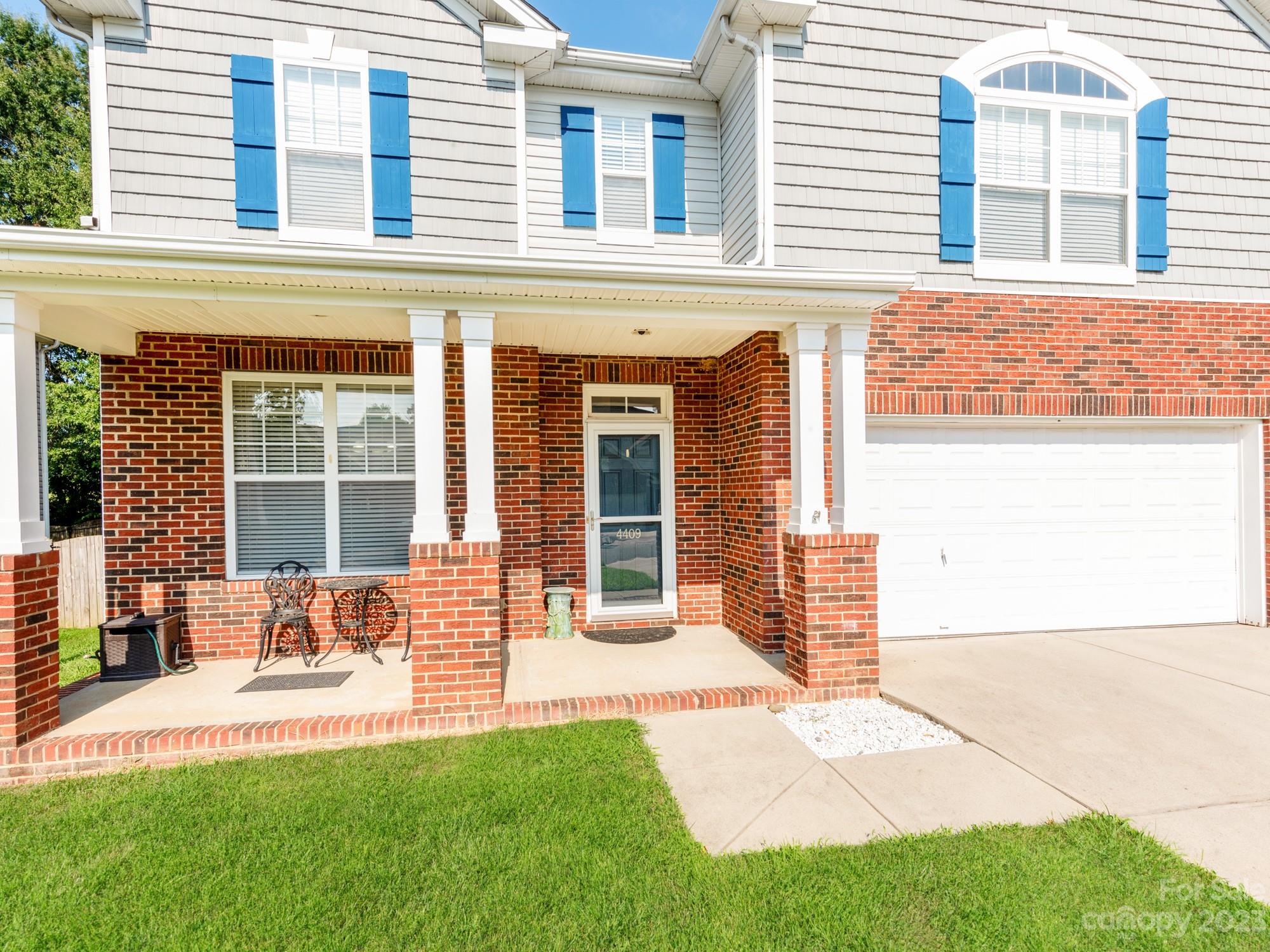4409 Lawrence Daniel Drive Matthews, NC 28104 - Photo 3 of 38 a front view of a house with a yard and seating space