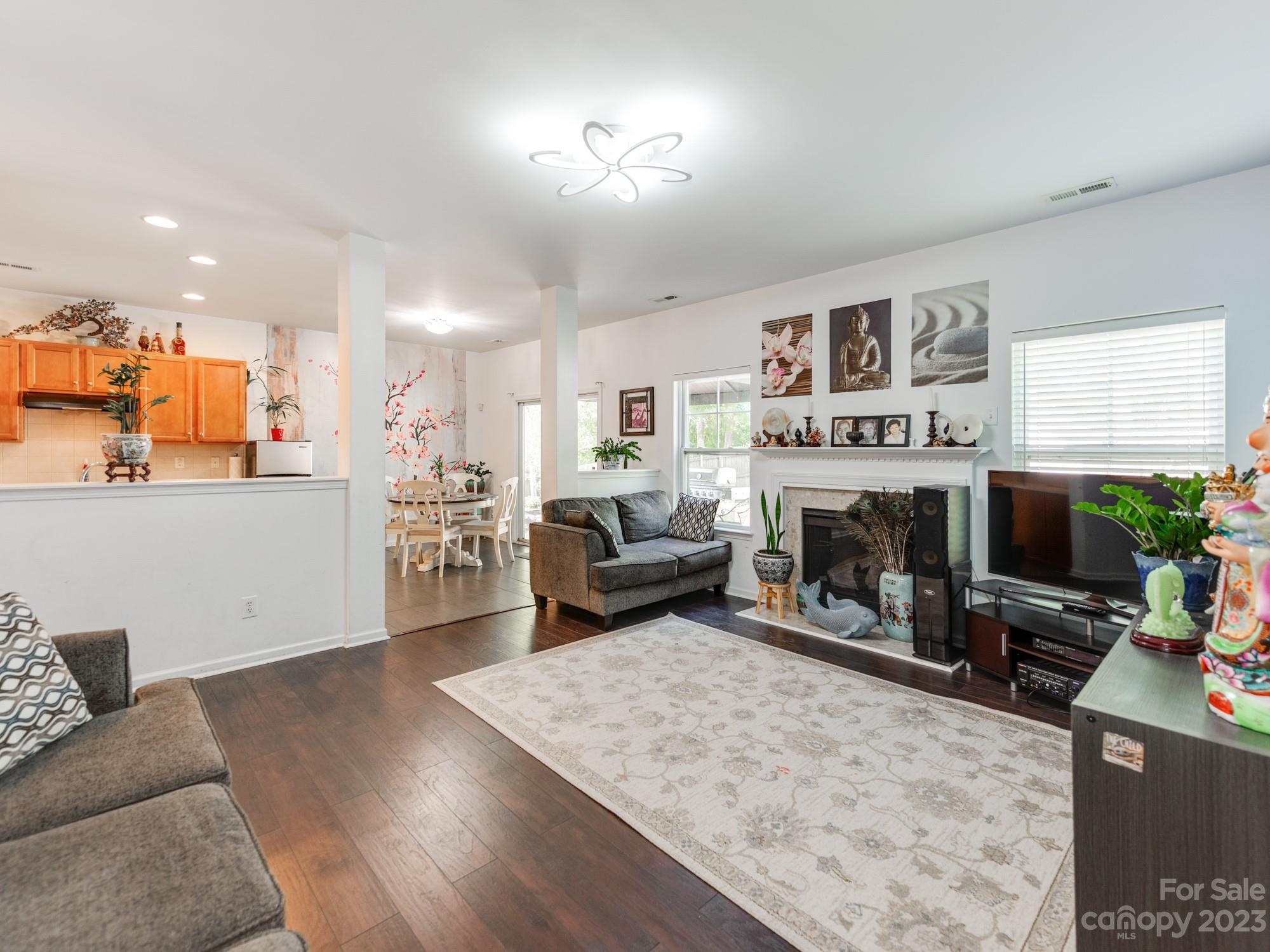 4409 Lawrence Daniel Drive Matthews, NC 28104 - Photo 9 of 38 a living room with furniture and a fireplace