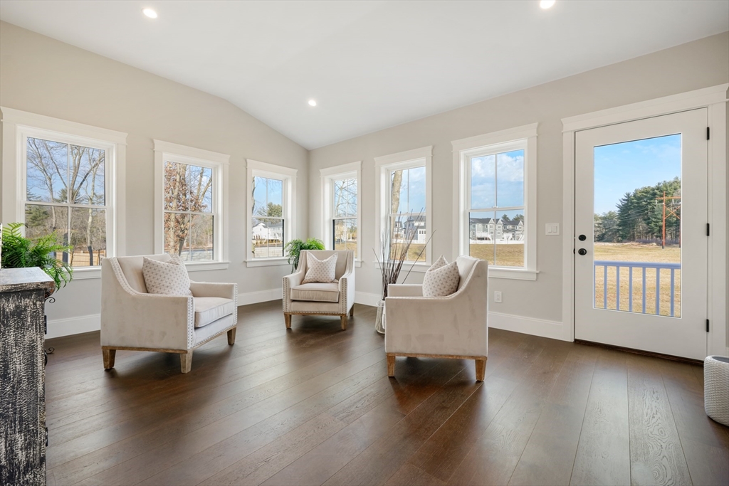 8 Wayside Road Natick, MA 01760 - Photo 14 of 42 a living room with couches and a coffee table with wooden floor