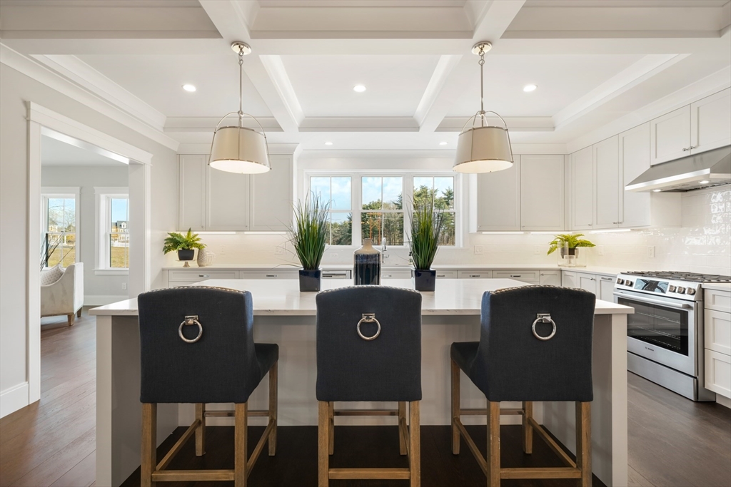 8 Wayside Road Natick, MA 01760 - Photo 2 of 42 a kitchen with stainless steel appliances granite countertop a stove a refrigerator a oven a dining table and chairs with wooden floor