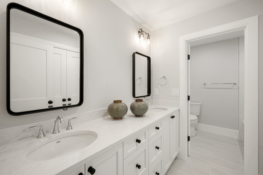 8 Wayside Road Natick, MA 01760 - Photo 24 of 42 a bathroom with a double vanity sink and mirror
