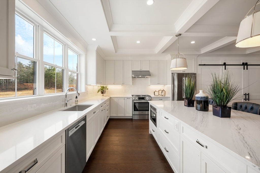 8 Wayside Road Natick, MA 01760 - Photo 3 of 42 a large white kitchen with a large window and stainless steel appliances