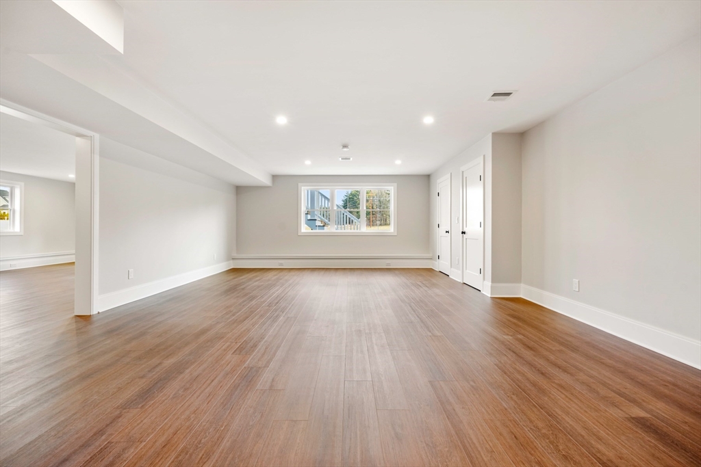 8 Wayside Road Natick, MA 01760 - Photo 39 of 42 an empty room with wooden floor and windows