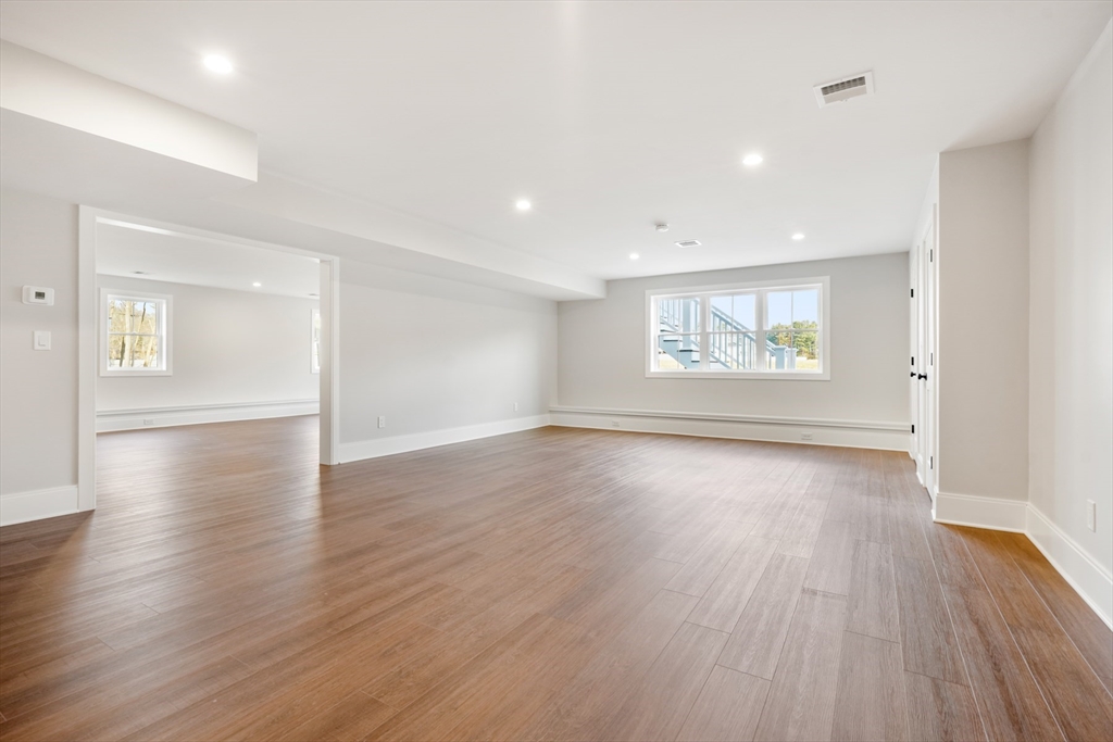 8 Wayside Road Natick, MA 01760 - Photo 40 of 42 an empty room with wooden floor and windows