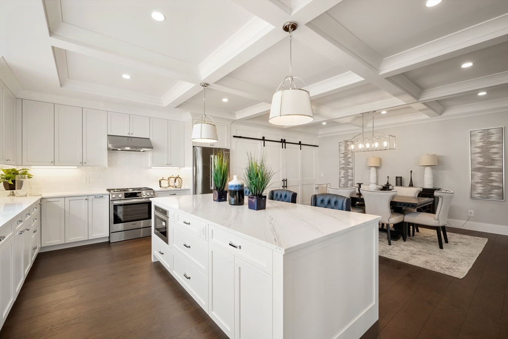 8 Wayside Road Natick, MA 01760 - Photo 4 of 42 a large white kitchen with lots of counter space dining table and stainless steel appliances