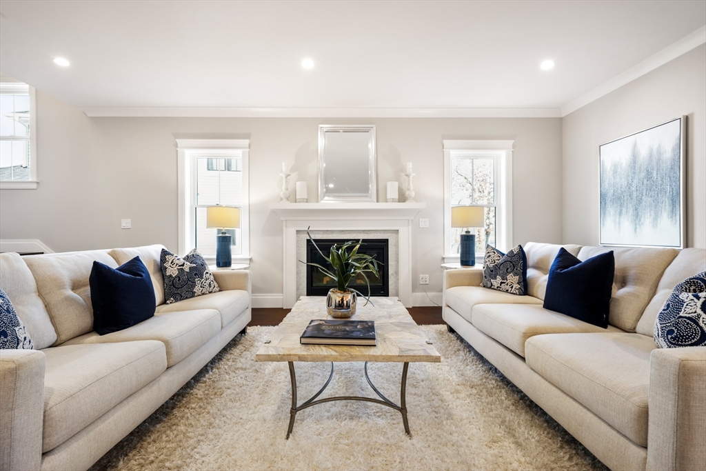 8 Wayside Road Natick, MA 01760 - Photo 10 of 42 a living room with furniture and a fireplace