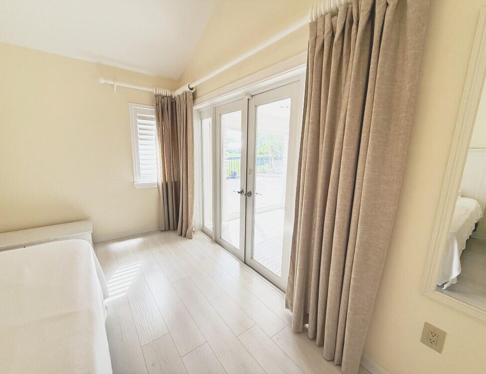 114 Beach Summit Court Jupiter, FL 33477 - Photo 15 of 32 a view of a room with a wooden floor and a window