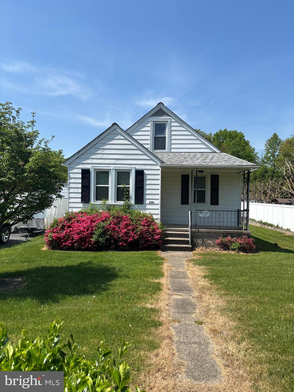 a front view of a house with garden and porch