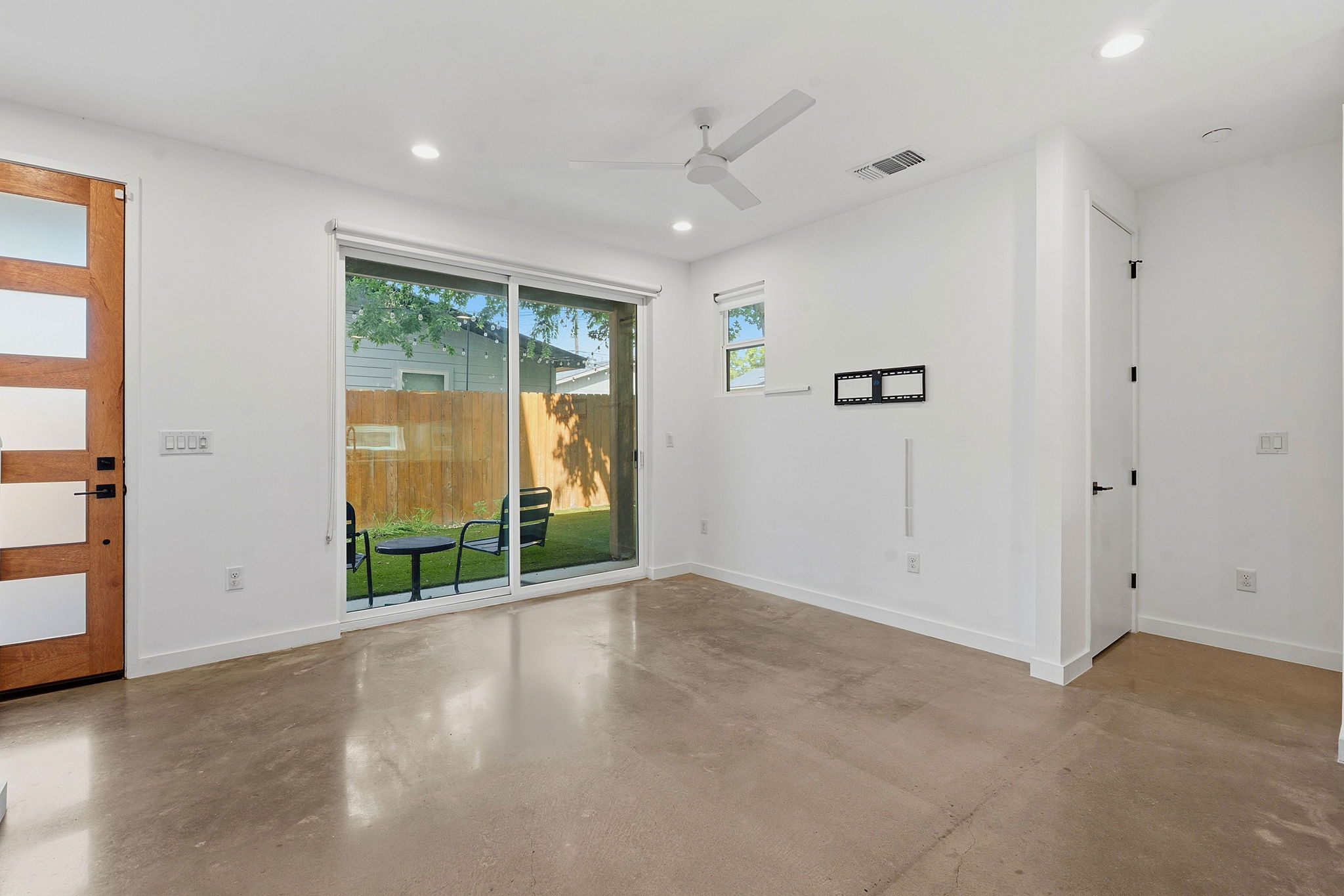 1707 Deloney Street, Unit 2 Austin, TX 78721 - Photo 3 of 26 Polished concrete floors flow through this luminous living space, offering direct backyard access.